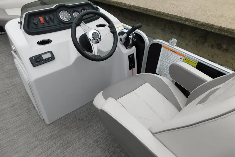 Slide: The Image of 2021 Godfrey Sweetwater 2286 SBX boat helm with steering wheel and control panel. - 23