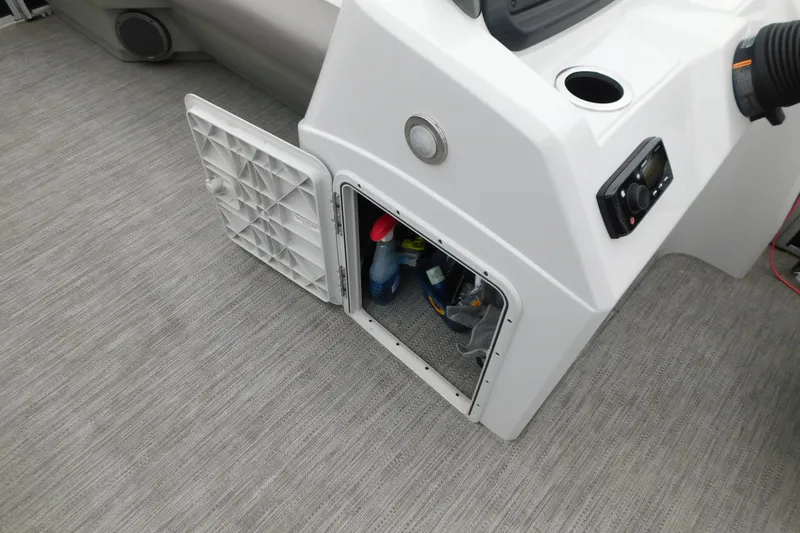 Slide: The Image of Open storage compartment on 2021 Godfrey Sweetwater 2286 SBX boat, showing cleaning supplies. - 28