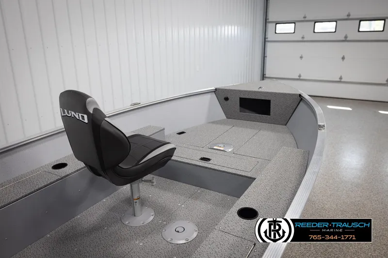 Slide: The Image of 2026 Lund 1600 Fury Tiller boat interior with seating and storage compartments. - 13