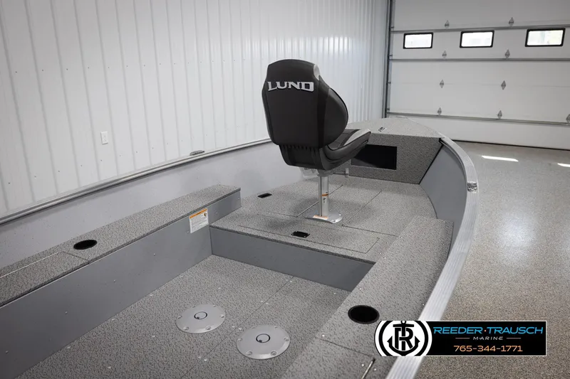 Slide: The Image of 2026 Lund 1600 Fury Tiller boat interior with seating and storage compartments. - 14