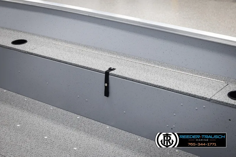 Slide: The Image of 2026 Lund 1600 Fury Tiller boat interior with storage compartment and cup holders. - 16