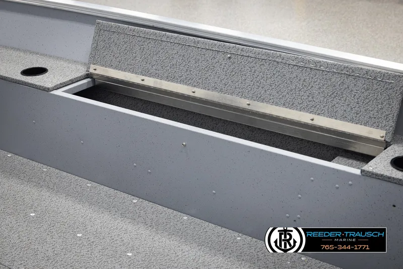 Slide: The Image of 2026 Lund 1600 Fury Tiller boat interior with storage compartment and cup holder. - 17