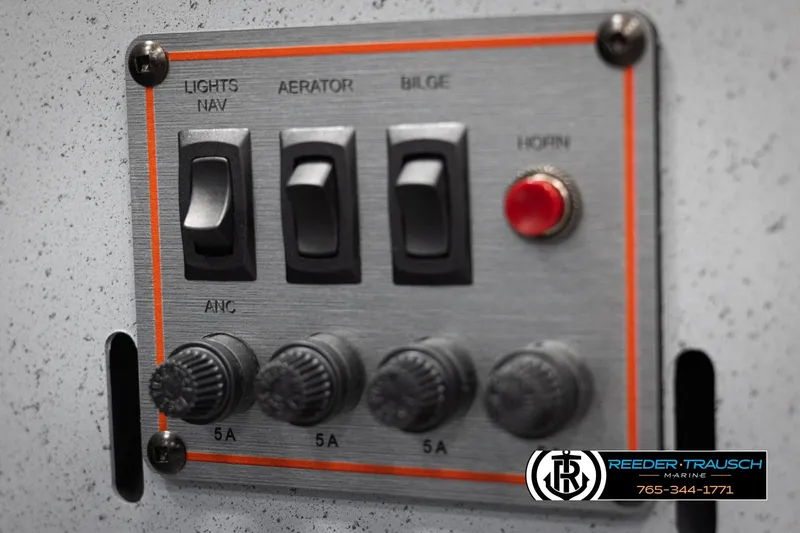 Slide: The Image of Control panel of 2026 Lund 1600 Fury Tiller boat with switches and knobs. - 18
