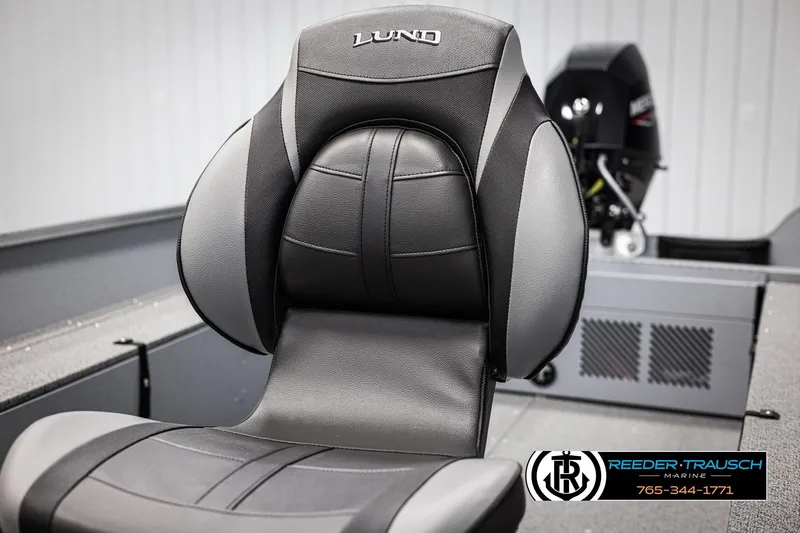 Slide: The Image of 2026 Lund 1600 Fury Tiller boat seat with logo, featuring sleek black and gray design. - 19