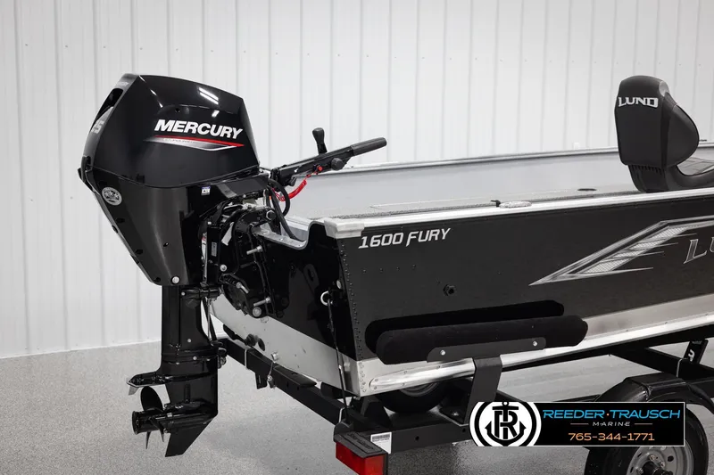 Slide: The Image of 2026 Lund 1600 Fury Tiller boat with Mercury engine, displayed indoors. - 23