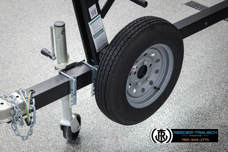 Slide: The Image of Trailer wheel and hitch of 2026 Lund 1600 Fury Tiller on showroom floor. - 30