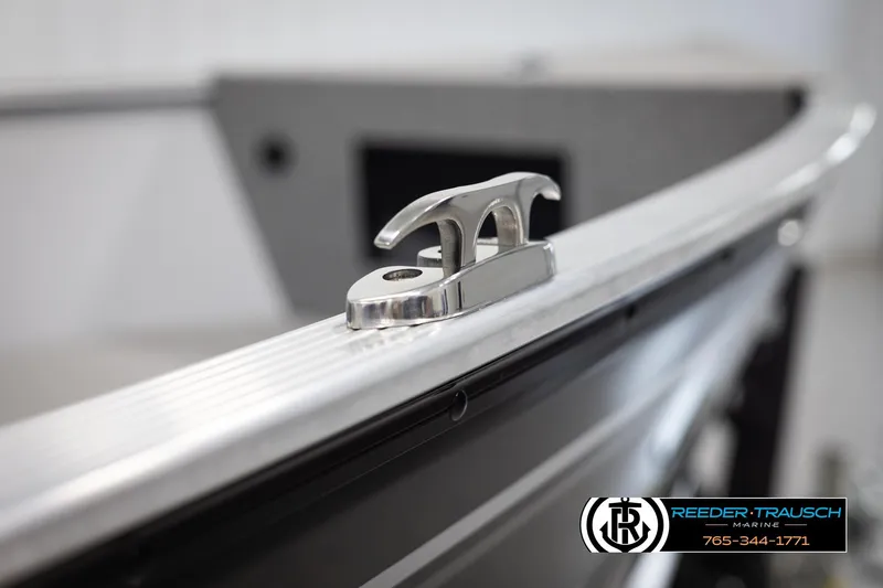 Slide: The Image of Close-up of a 2026 Lund 1600 Fury Tiller boat cleat, Reeder-Trausch Marine logo visible. - 32