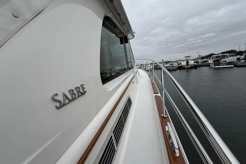 Slide: The Image of 2023 Sabre 43 Salon Express yacht docked at marina, showcasing sleek design and craftsmanship. - 102