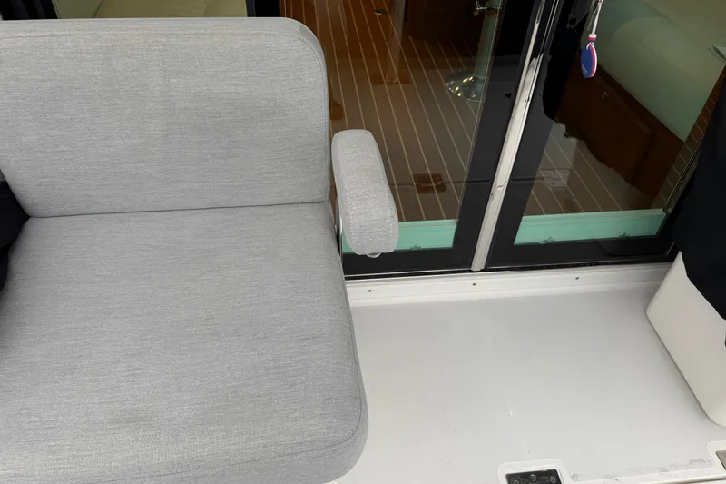 Slide: The Image of Gray seating on 2023 Sabre 43 Salon Express yacht, near glass doors. - 106