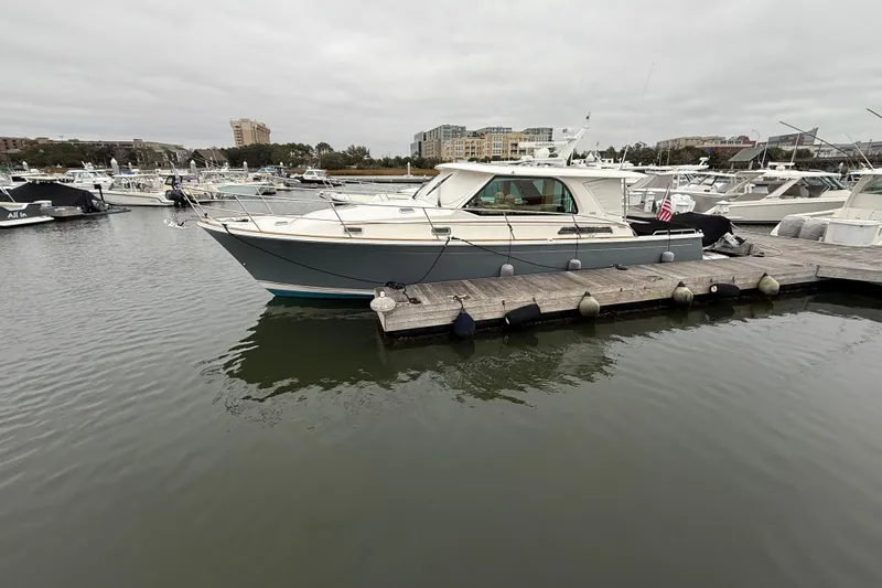 Slide: The Image of 2023 Sabre 43 Salon Express yacht docked in a marina, surrounded by other boats. - 107