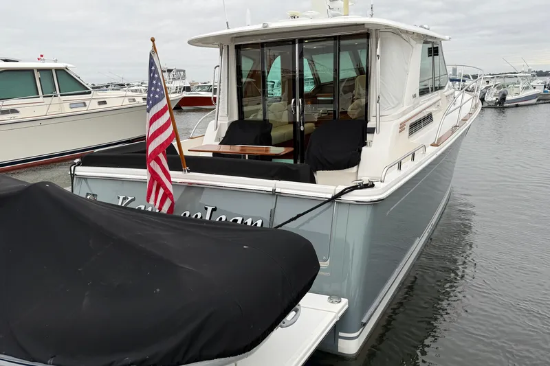 Slide: The Image of 2023 Sabre 43 Salon Express yacht docked with American flag displayed. - 109