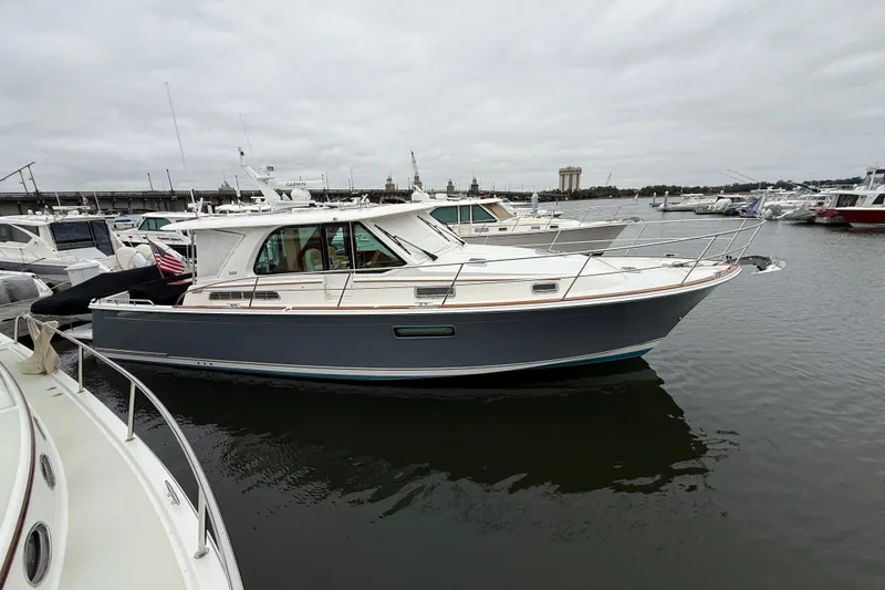 Slide: The Image of 2023 Sabre 43 Salon Express yacht docked in a marina, overcast sky. - 112