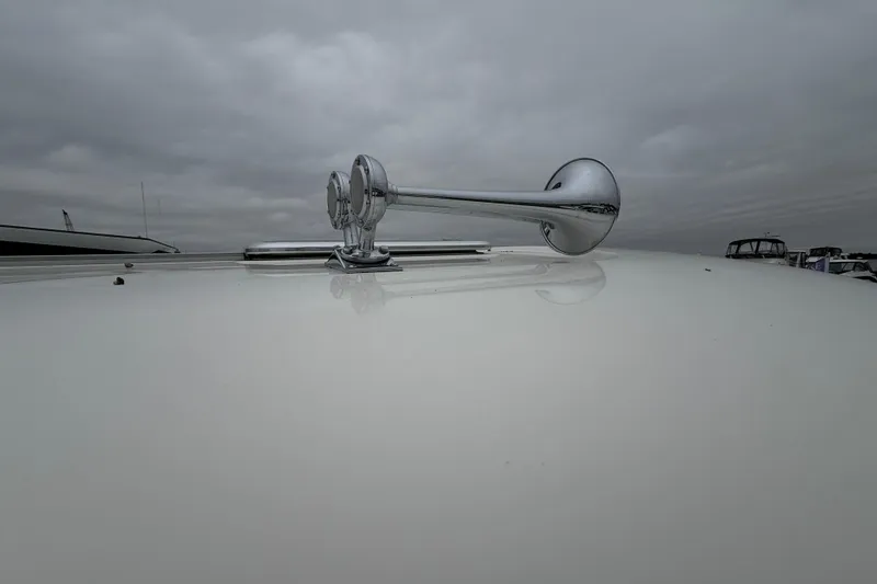 Slide: The Image of Chrome horn on 2023 Sabre 43 Salon Express yacht under cloudy sky. - 12