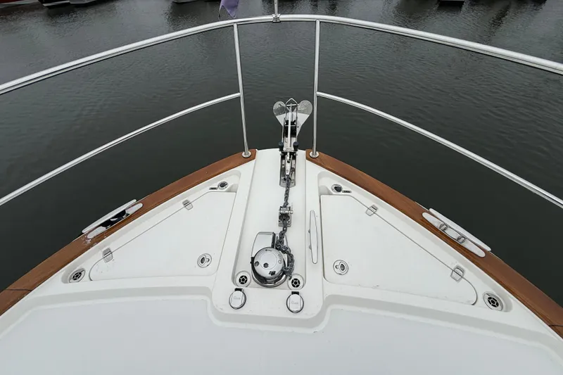 Slide: The Image of Bow view of 2023 Sabre 43 Salon Express yacht with anchor and railing. - 18