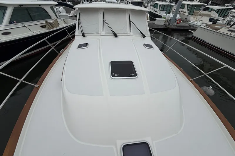 Slide: The Image of 2023 Sabre 43 Salon Express yacht docked at marina, showcasing sleek deck design. - 20