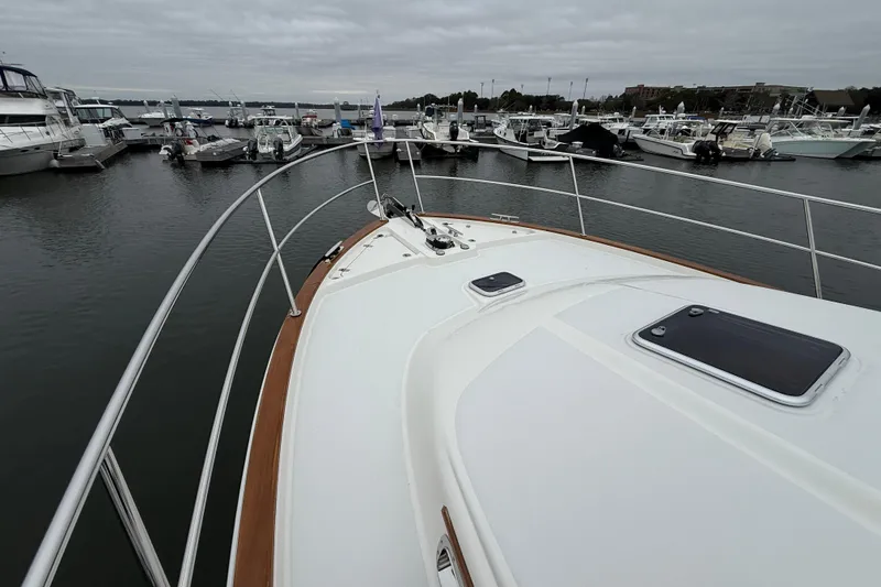 Slide: The Image of 2023 Sabre 43 Salon Express yacht docked at marina under cloudy skies. - 21