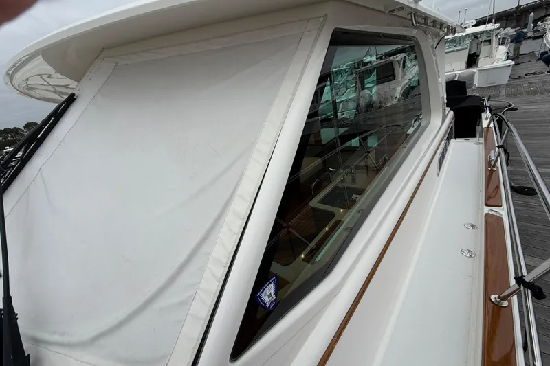 Slide: The Image of 2023 Sabre 43 Salon Express yacht with covered windows docked at marina. - 23