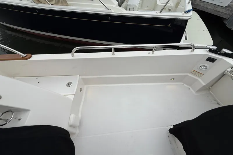 Slide: The Image of 2023 Sabre 43 Salon Express boat deck, featuring clean white surface and railing. - 24