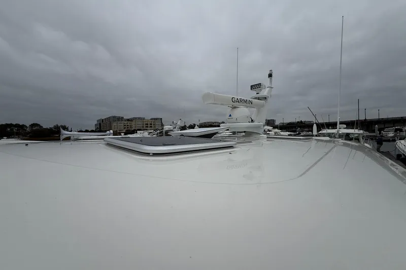 Slide: The Image of 2023 Sabre 43 Salon Express yacht with Garmin radar, docked under cloudy skies. - 25