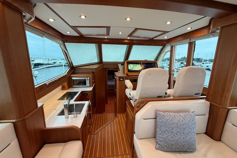 Slide: The Image of Interior of 2023 Sabre 43 Salon Express yacht with luxurious seating and navigation area. - 29