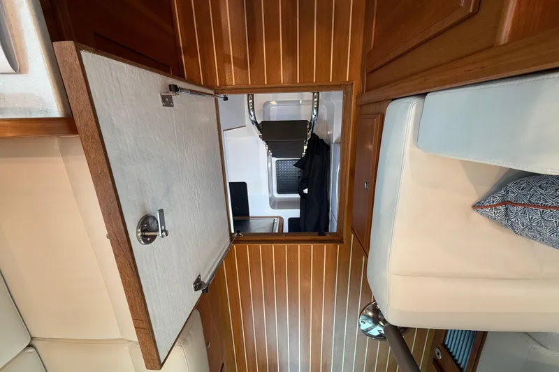 Slide: The Image of 2023 Sabre 43 Salon Express interior with open wooden hatch and seating area. - 34