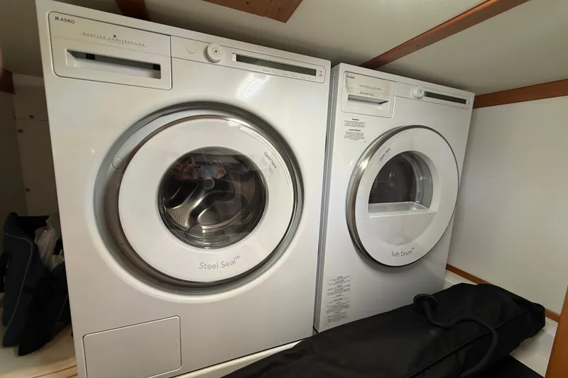 Slide: The Image of Laundry appliances inside 2023 Sabre 43 Salon Express yacht, featuring Asko washer and dryer. - 35