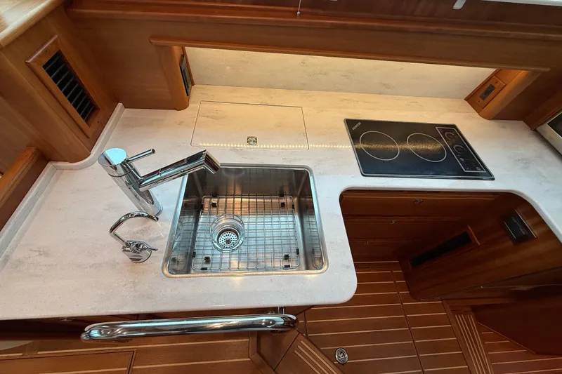 Slide: The Image of 2023 Sabre 43 Salon Express yacht kitchen with sink and stovetop. - 41