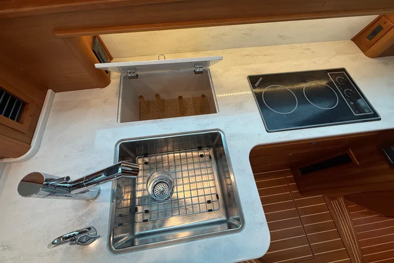 Slide: The Image of Modern kitchen area in 2023 Sabre 43 Salon Express yacht with sink and cooktop. - 42