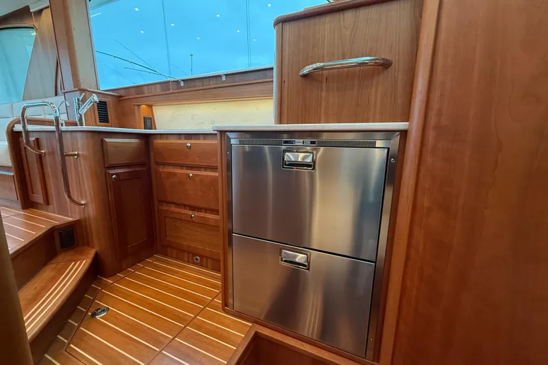 Slide: The Image of Luxurious interior of 2023 Sabre 43 Salon Express yacht with wood cabinetry and stainless appliances. - 59