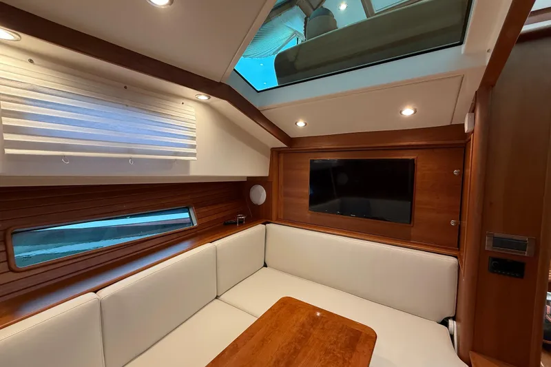 Slide: The Image of Luxurious interior of 2023 Sabre 43 Salon Express yacht with wood paneling and skylight. - 63
