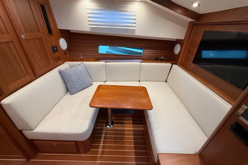 Slide: The Image of 2023 Sabre 43 Salon Express interior with cozy seating and wooden table. - 64