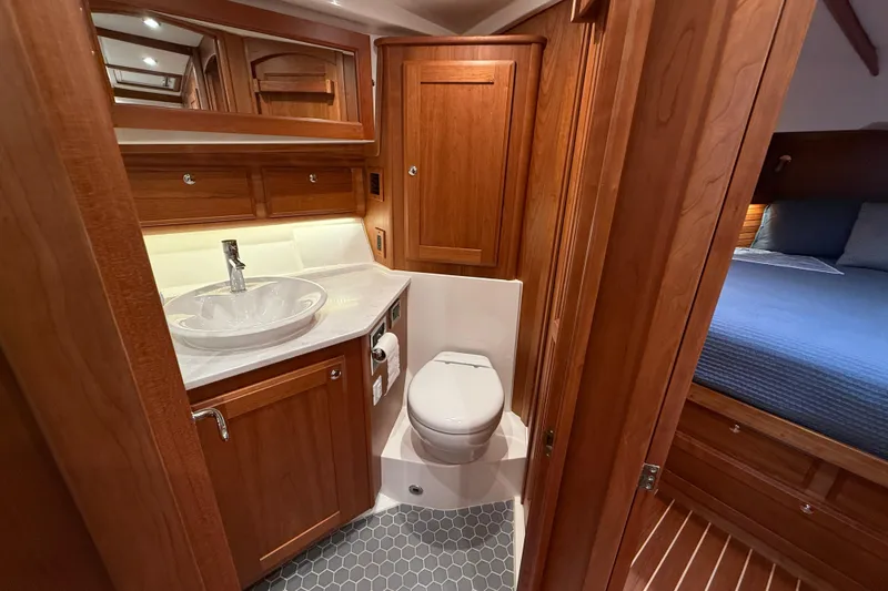 Slide: The Image of 2023 Sabre 43 Salon Express bathroom with wood cabinetry and modern fixtures. - 67