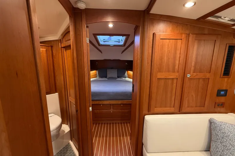 Slide: The Image of 2023 Sabre 43 Salon Express interior with wood finish, cozy bedroom, and modern bathroom. - 70