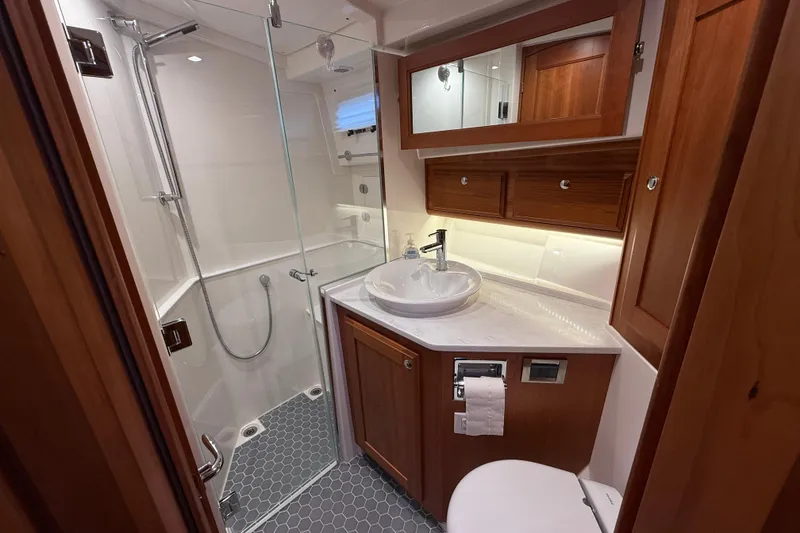 Slide: The Image of Luxurious bathroom in 2023 Sabre 43 Salon Express yacht with modern fixtures and wood accents. - 77