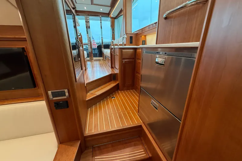 Slide: The Image of 2023 Sabre 43 Salon Express interior with wood finish and modern appliances. - 81