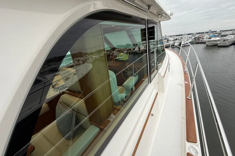 Slide: The Image of 2023 Sabre 43 Salon Express yacht, side view with marina reflection. - 9