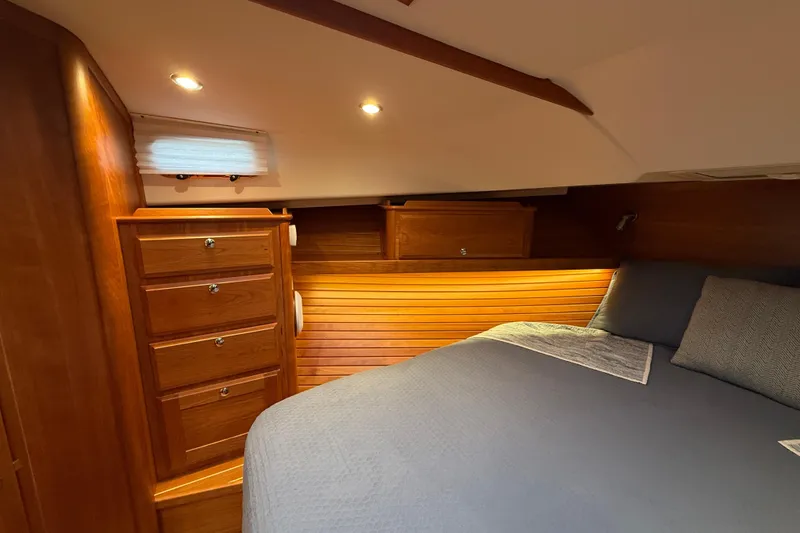 Slide: The Image of Luxurious 2023 Sabre 43 Salon Express cabin with elegant wood finish and cozy bedding. - 91