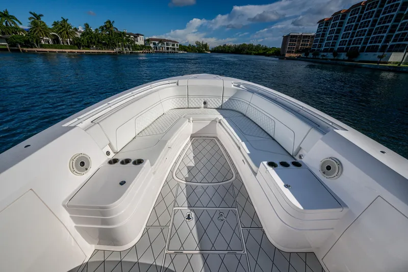 Slide: The Image of 2020 Intrepid 375 Nomad SE boat interior with spacious seating and scenic waterfront view. - 14