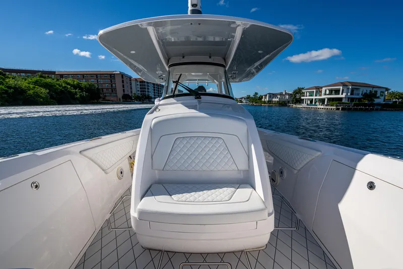 Slide: The Image of 2020 Intrepid 375 Nomad SE boat on water, featuring luxurious seating and sleek design. - 18