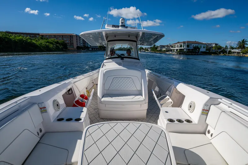 Slide: The Image of 2020 Intrepid 375 Nomad SE boat cruising on a sunny day, featuring spacious seating. - 19