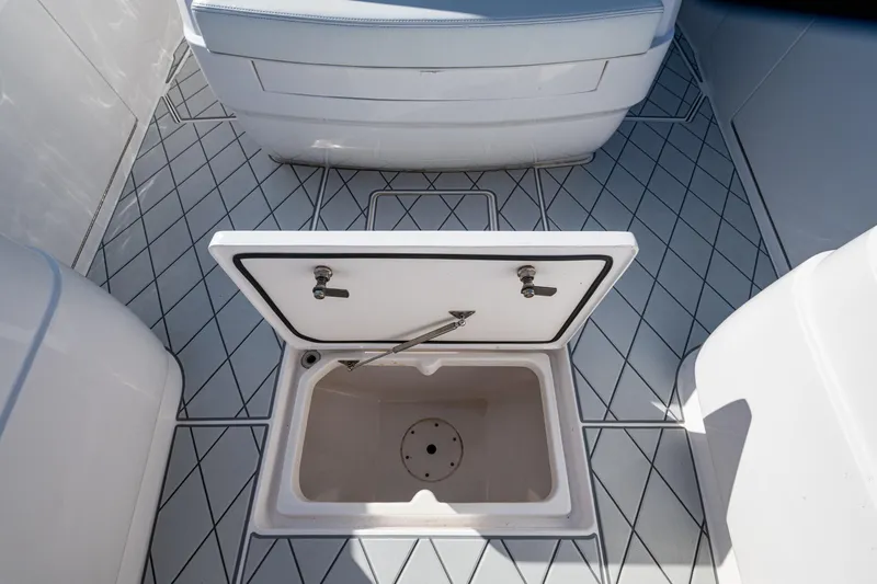 Slide: The Image of 2020 Intrepid 375 Nomad SE boat with open storage compartment on deck. - 21