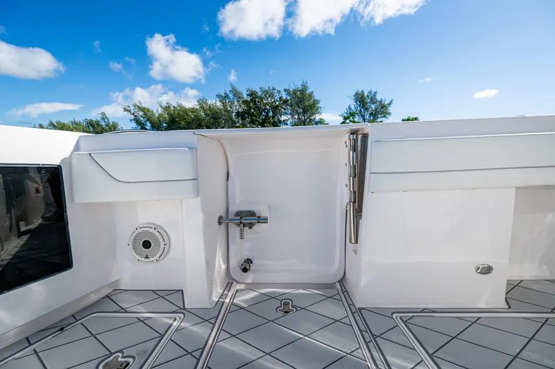 Slide: The Image of 2020 Intrepid 375 Nomad SE boat deck with sleek design and clear blue sky. - 26