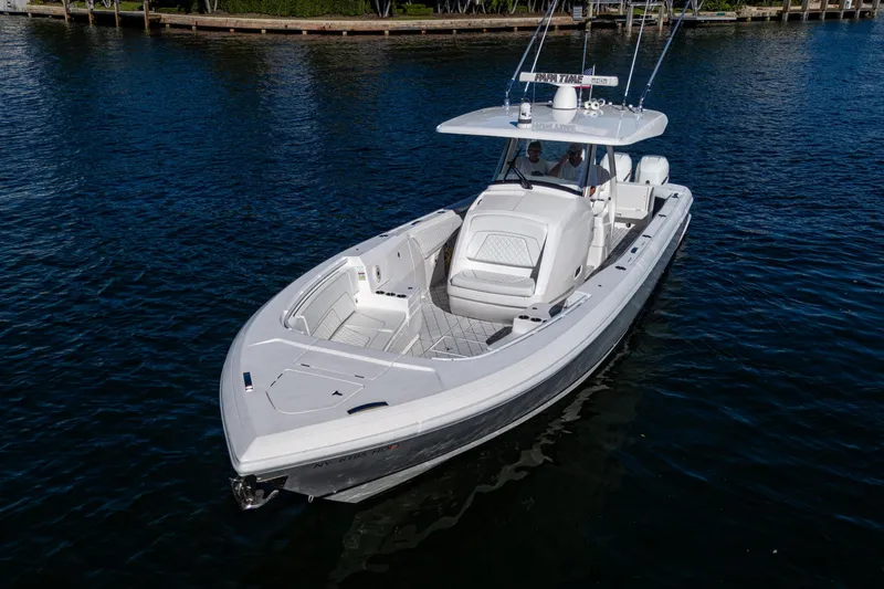 Slide: The Image of 2020 Intrepid 375 Nomad SE boat cruising on calm blue water. - 4