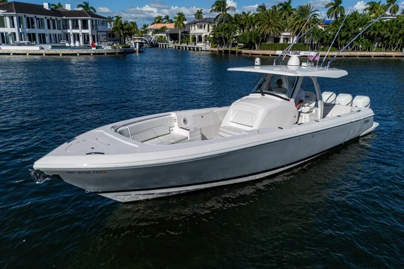 Slide: The Image of 2020 Intrepid 375 Nomad SE boat on calm water near luxury waterfront homes. - 5