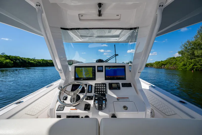 Slide: The Image of Cockpit view of 2020 Intrepid 375 Nomad SE boat on a scenic waterway. - 9