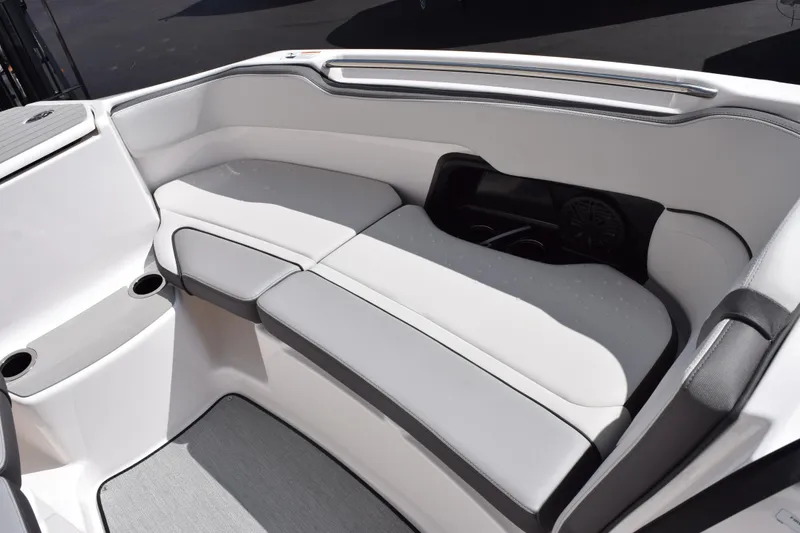 Slide: The Image of 2026 Yamaha Boats AR250 interior seating with cup holders and sleek design. - 13