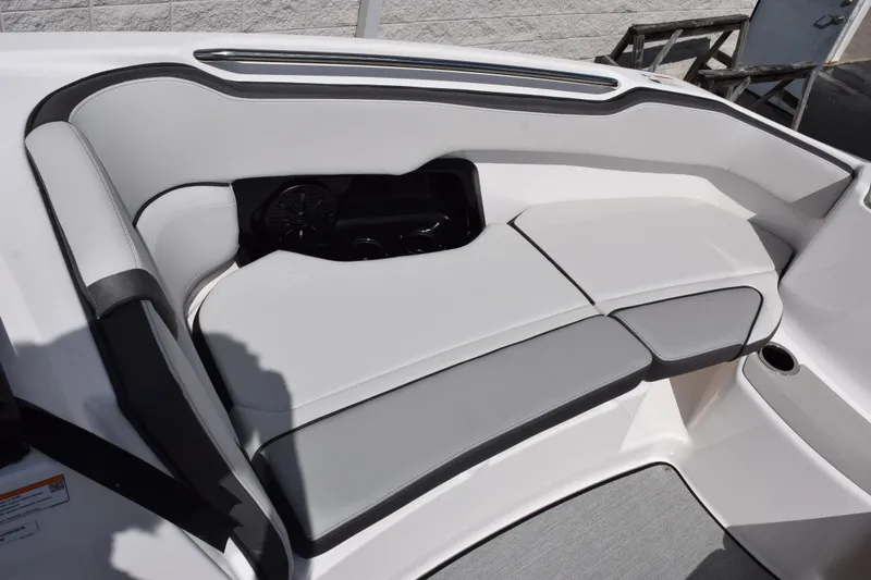 Slide: The Image of 2026 Yamaha Boats AR250 interior seating with sleek, modern design and integrated cup holders. - 14