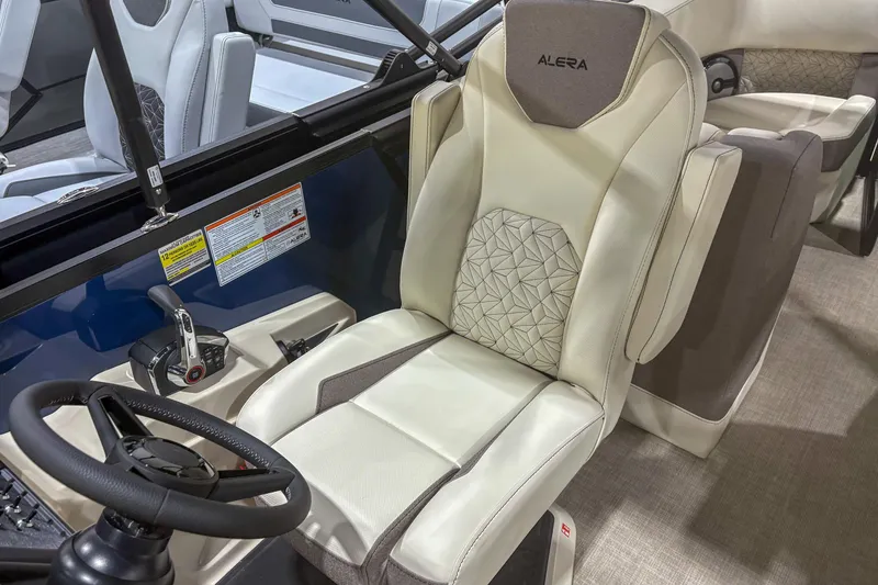 Slide: The Image of Captain's seat of 2026 Alera M23Q boat, featuring modern design and controls. - 9