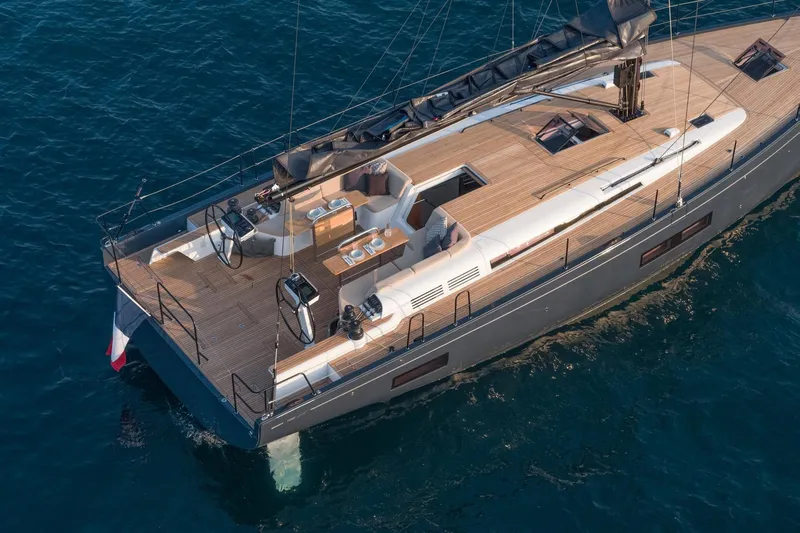 Slide: The Image of 2026 Beneteau First 53 yacht on calm blue waters, showcasing sleek design and spacious deck. - 1