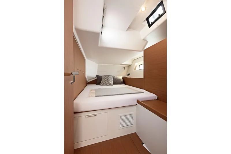 Slide: The Image of Luxurious cabin interior of 2026 Beneteau First 53 yacht, featuring modern design and cozy bedding. - 13